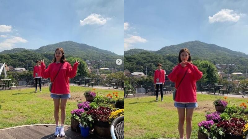 全昭旻更新个人SNS上传照片，穿著红色卫衣＋牛仔短裙，站在花丛边拍照
