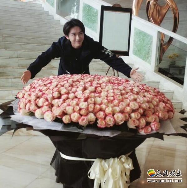 张逸杰微博致谢粉丝赠送礼物：配图晒出自己与巨型玫瑰花束合影照