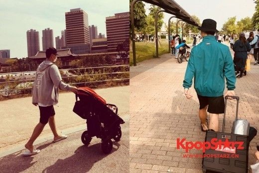 姜熙建打扮舒适随意 看起来像是野餐用品的箱子前行