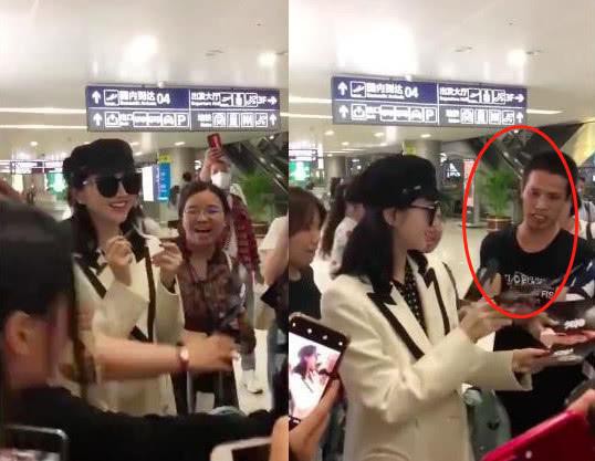 景甜现身机场被围观粉丝中一名男粉丝拽住手臂激动表白：更是借机摸手