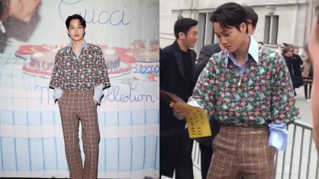 KAI从粉丝面前经过，看到粉丝手里横幅很好奇，抬手指了指想要拿过来看